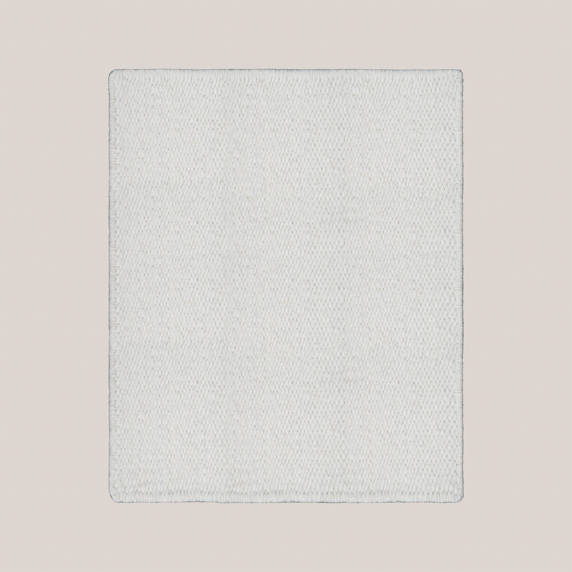 Handwoven Karakul wool rug in a minimalist design featuring a soft light color and textured surface.